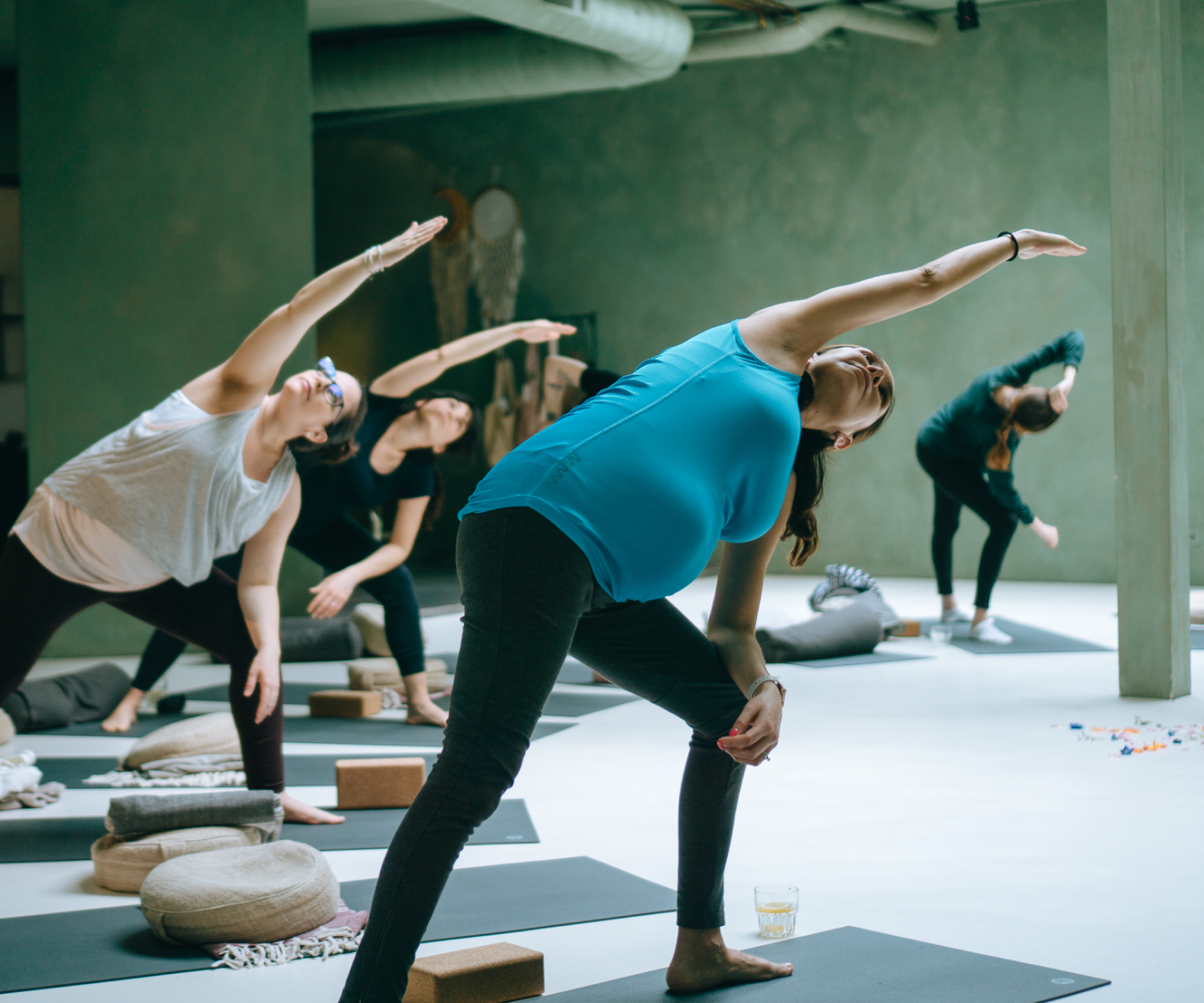 Group of pregnant people practicing yoga in a studio